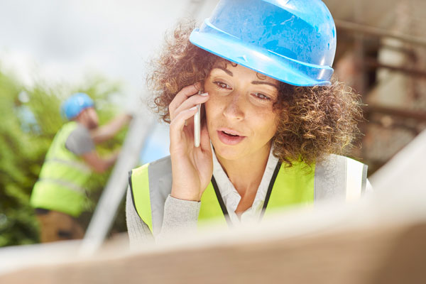 Construction worker speaking on the phone